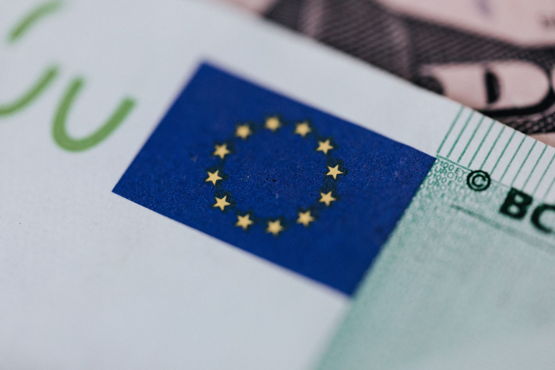 Gros plan sur le drapeau européen imprimé sur un billet en euros.